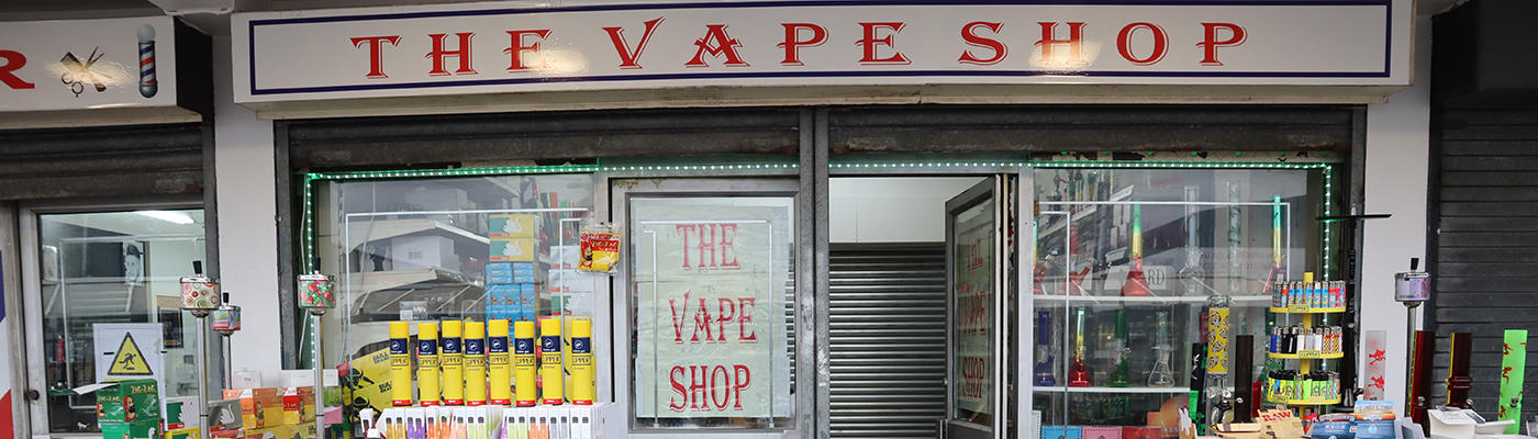 The Vape Shop front with an outside display of various coloured bottles