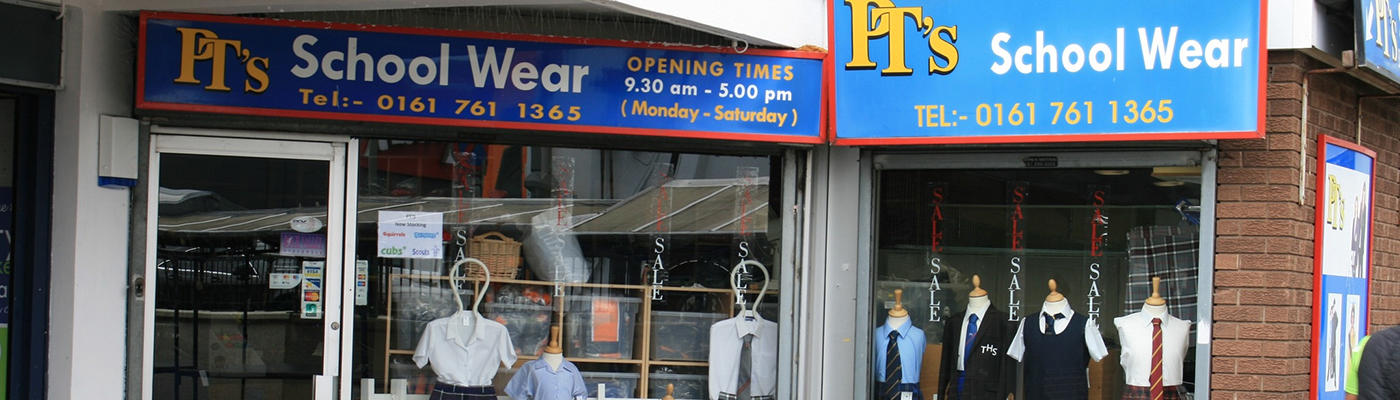 A shop front and window display of school uniforms for PT's School Wear