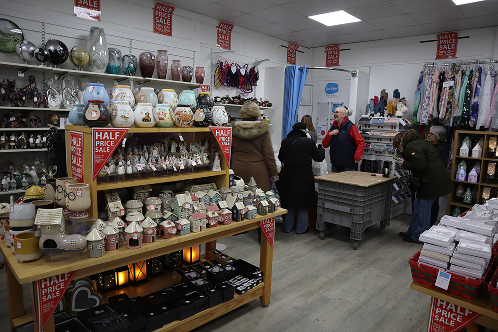 A shop with shelves of ceramic objects