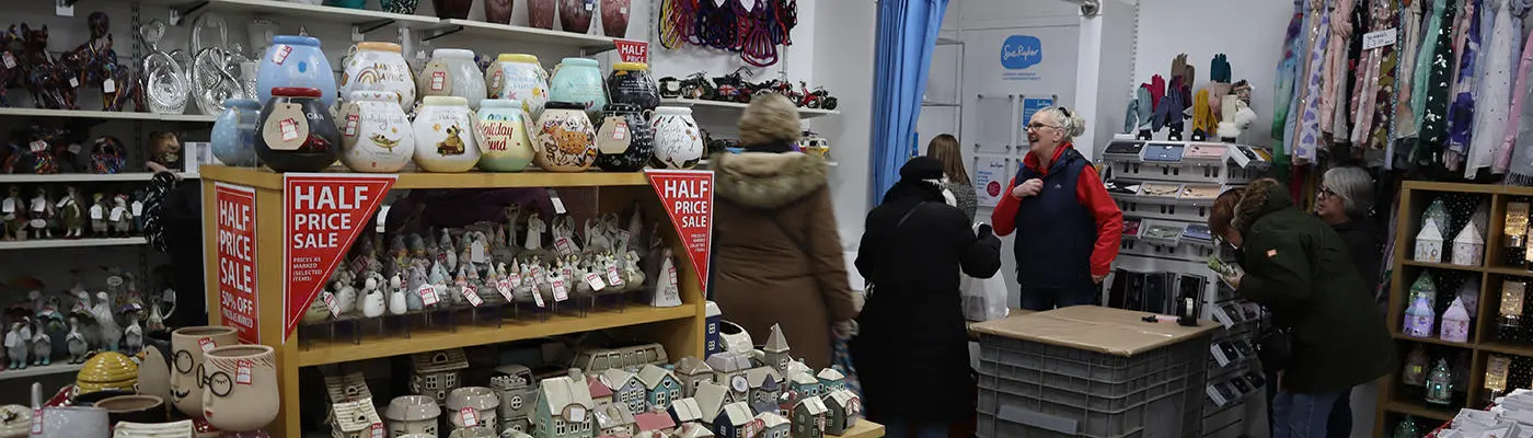 A shop with shelves of ceramic objects