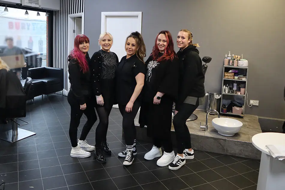 Five people standing in a row