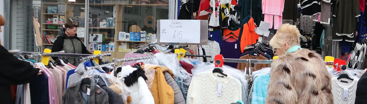 Clothes on rails outside a shop