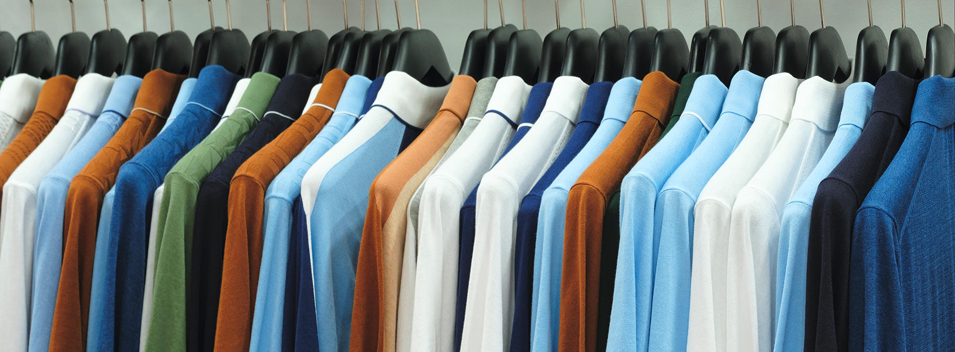 Row of colourful shirts on a clothes rail
