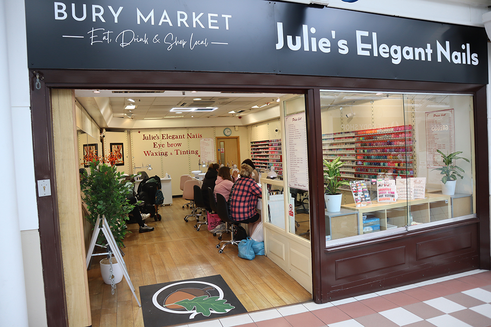 A view inside a nail salon with people sat inside