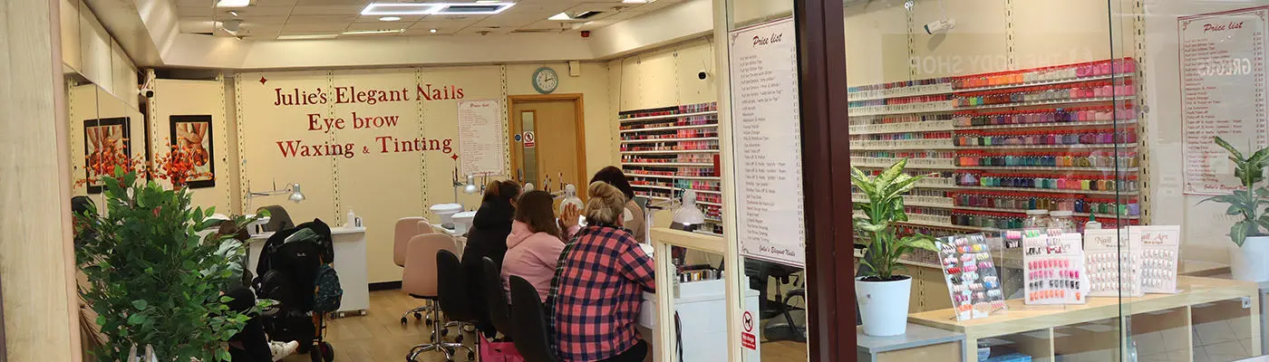 A view inside a nail salon with people sat inside
